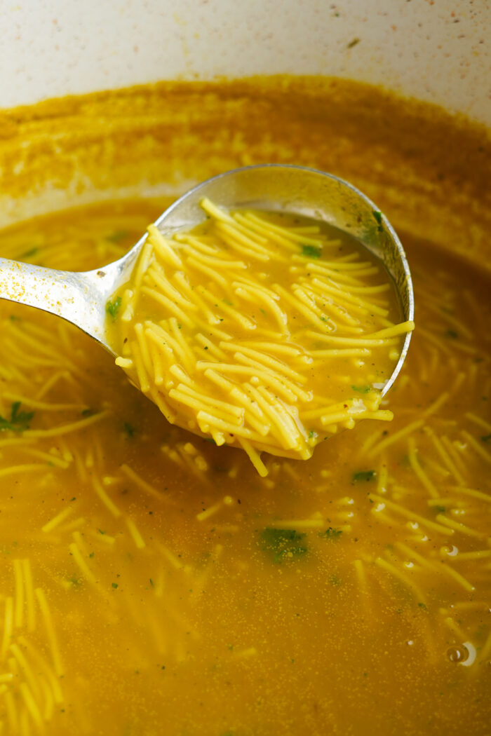 soup being poured in pot