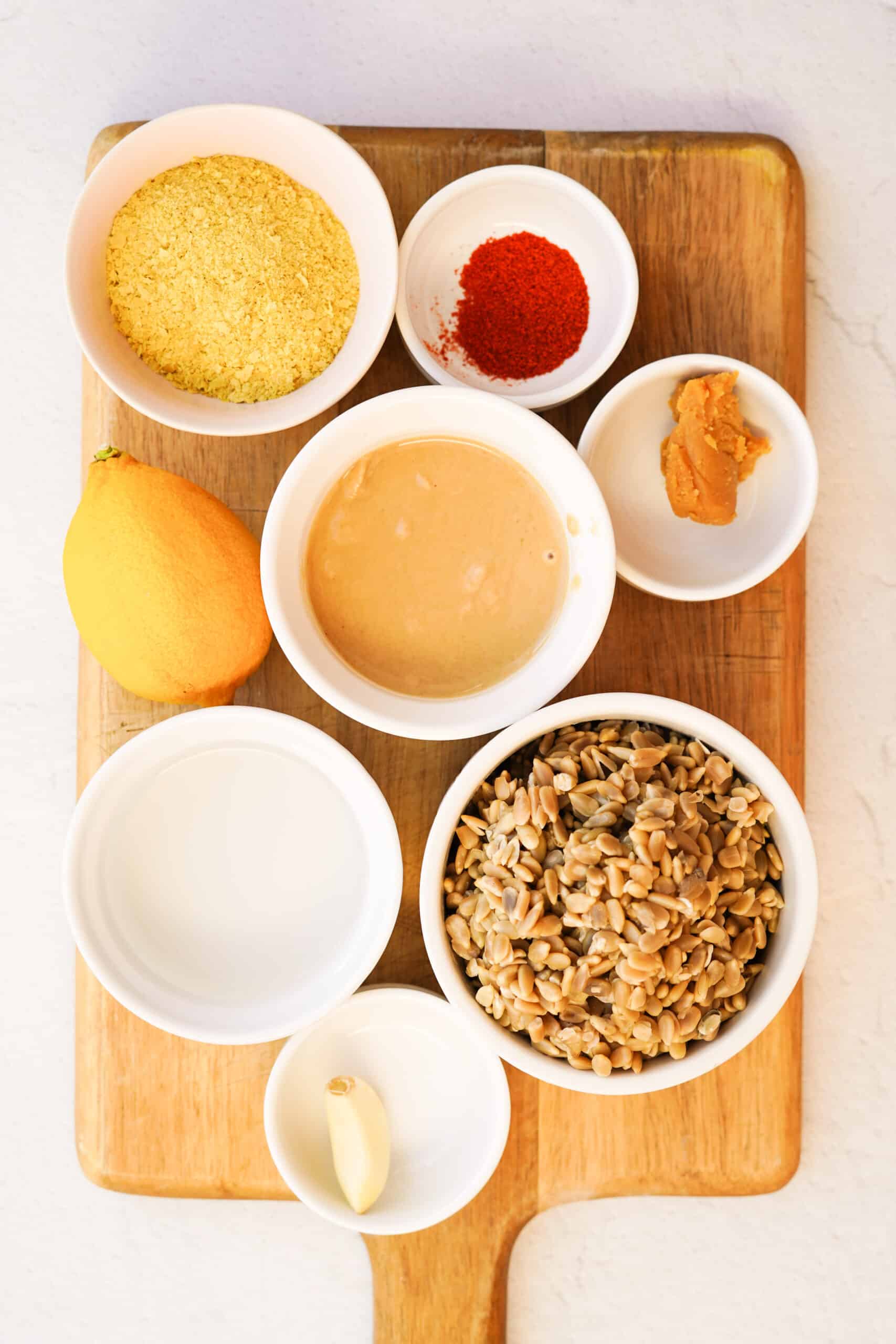 an overhead shot of a cutting board with vegan cheese ingredients