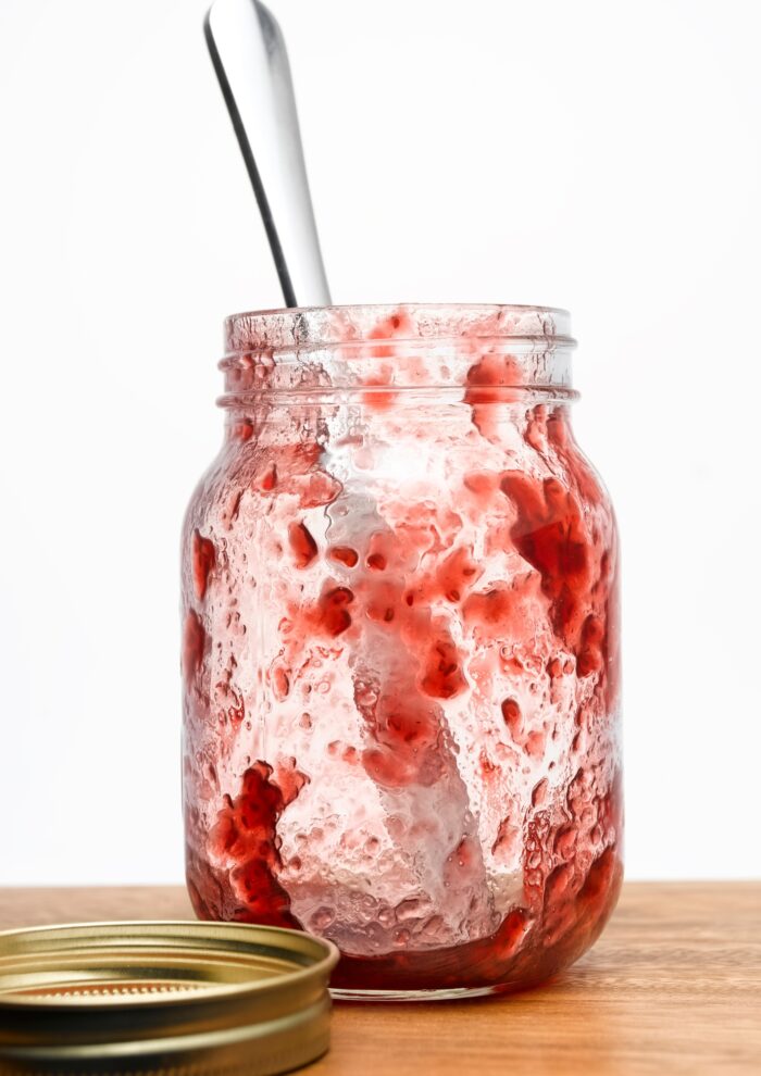 an empty strawberry jam jar