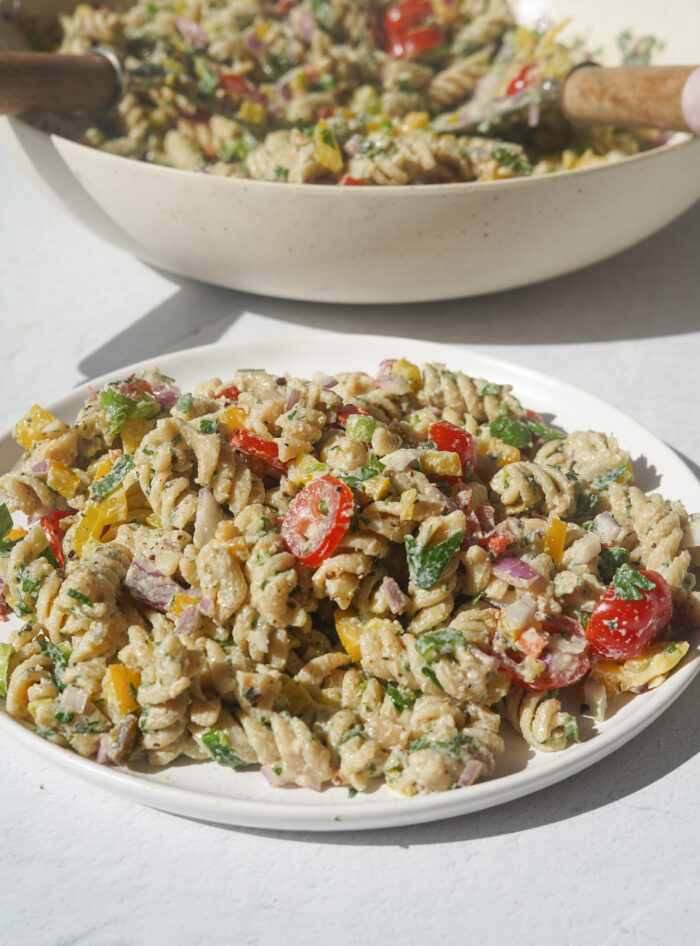 a pasta salad on a plate with a creamy dressing