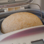 vegan loaf, freshly baked pictured in the bread maker machine