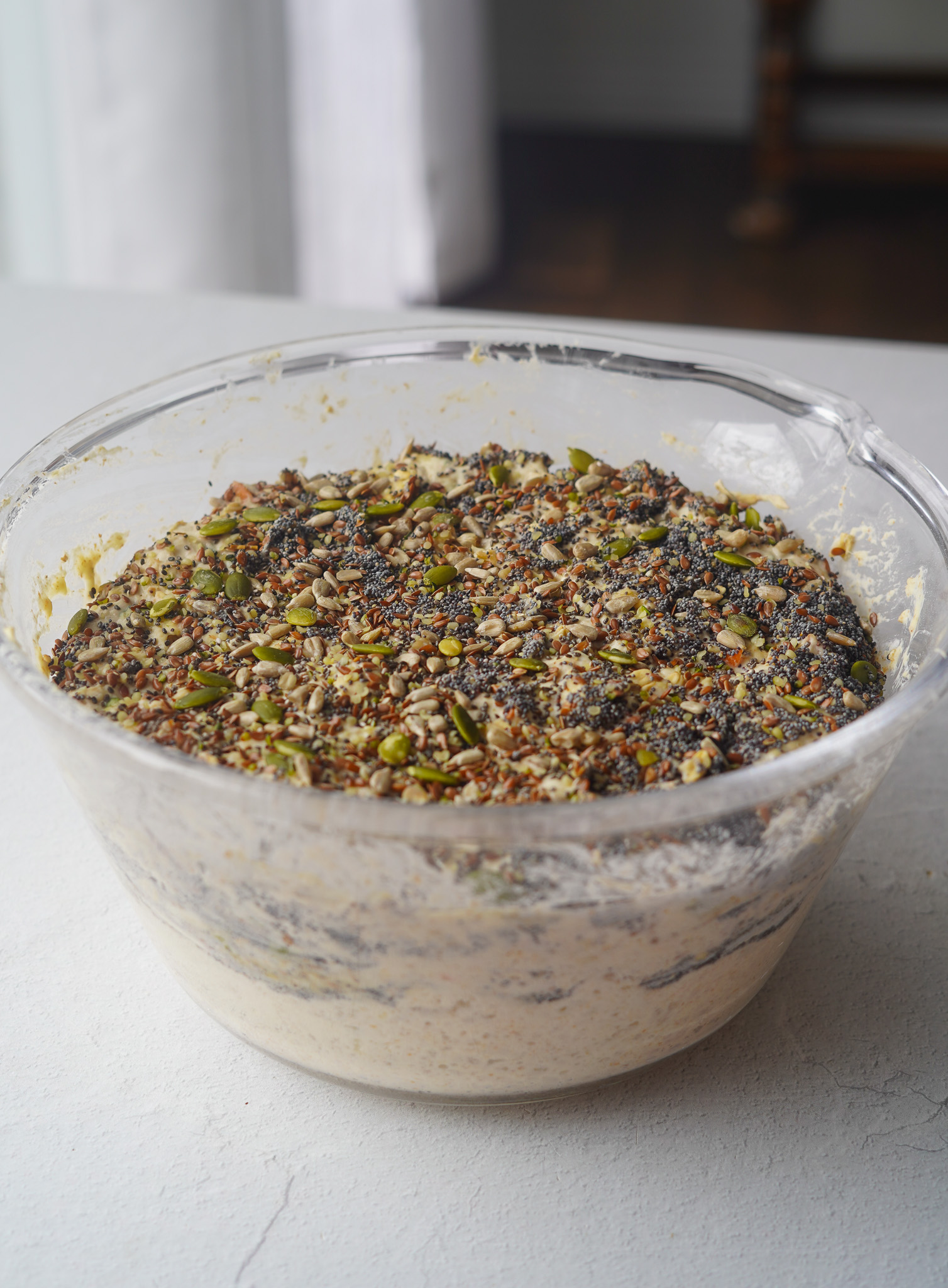 overnight oat bun dough topped with sunflower, pumpkin and poppy seeds