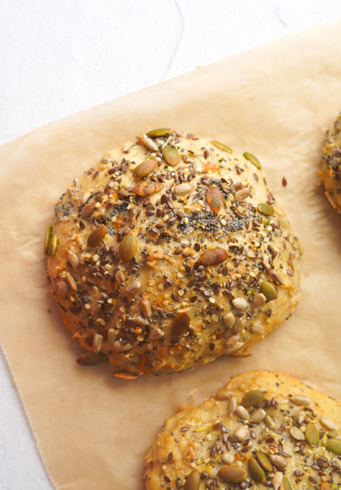 seeded wholemeal oat bun set on baking parchment