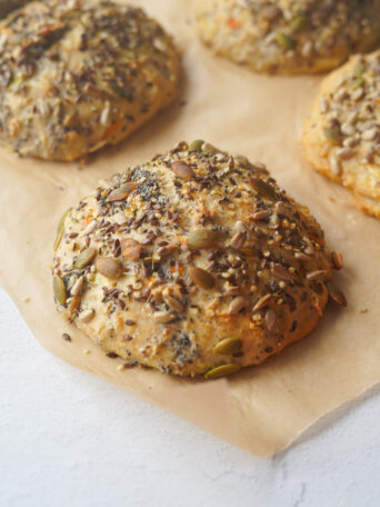 seeded wholemeal oat buns set on baking parchment