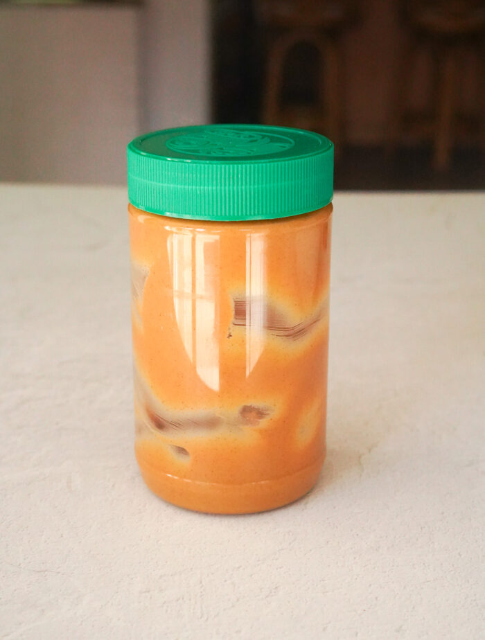 an empty peanut butter jar sitting on a counter