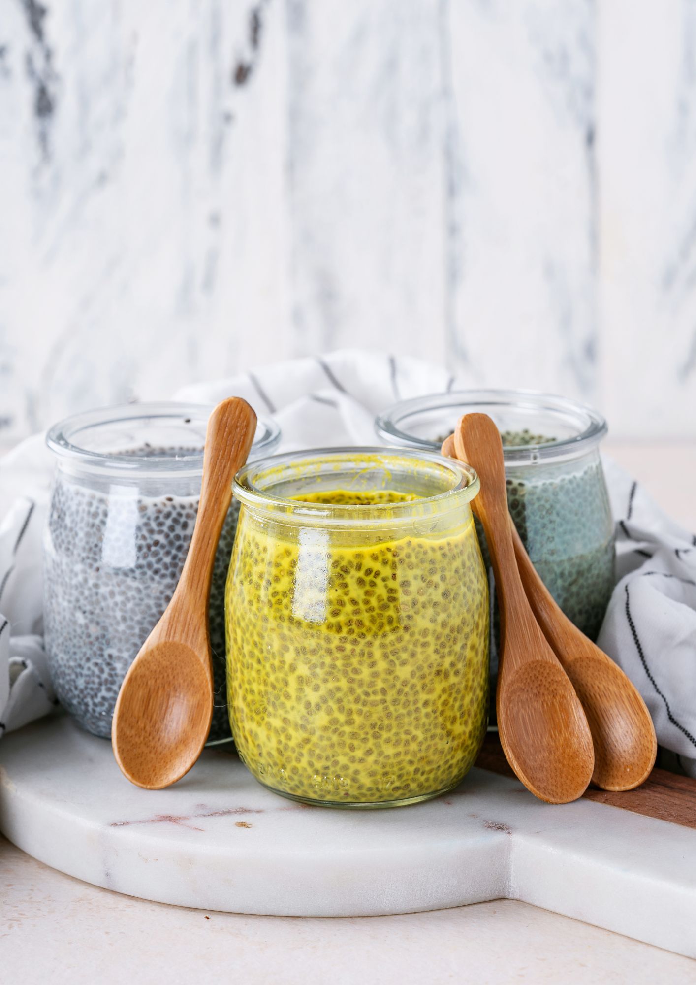 a jar full of mango chia pudding that is bright yellow