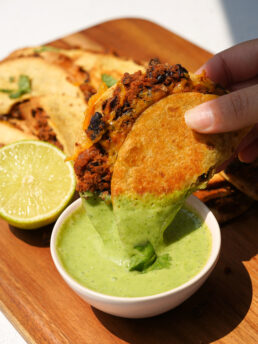 Crispy Black Bean Tacos dipped in herby lime dressing