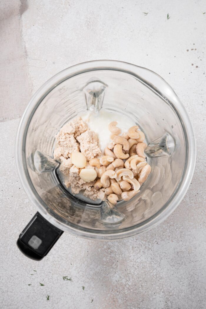 Vegan tzatziki ingredients in a blender, top down view.