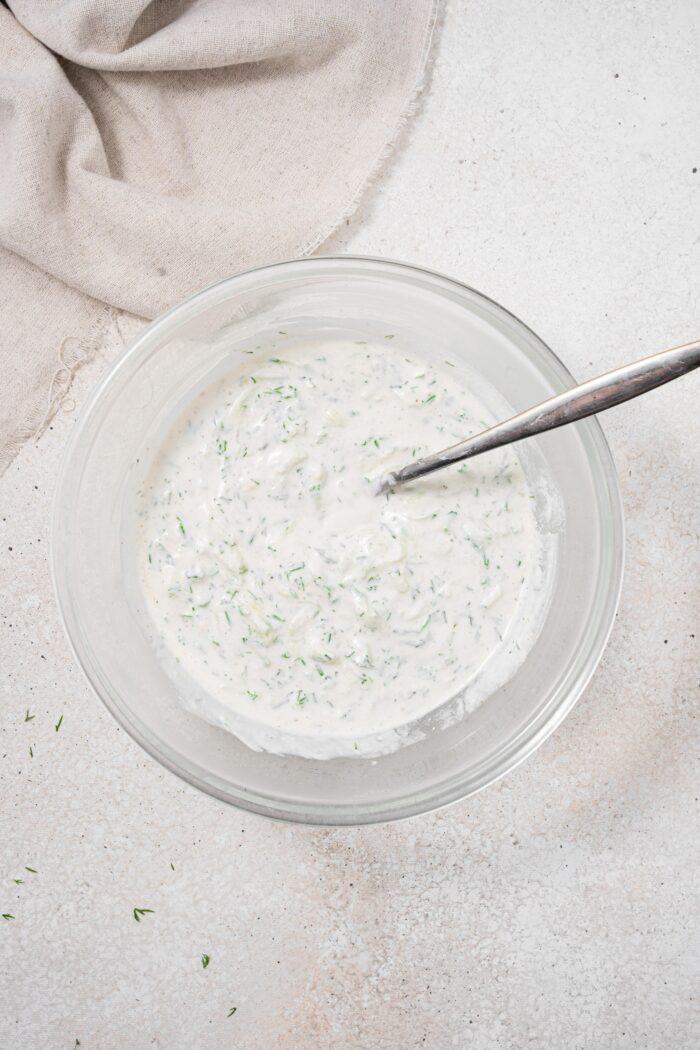 Vegan tzatziki dressing in a glass bowl.