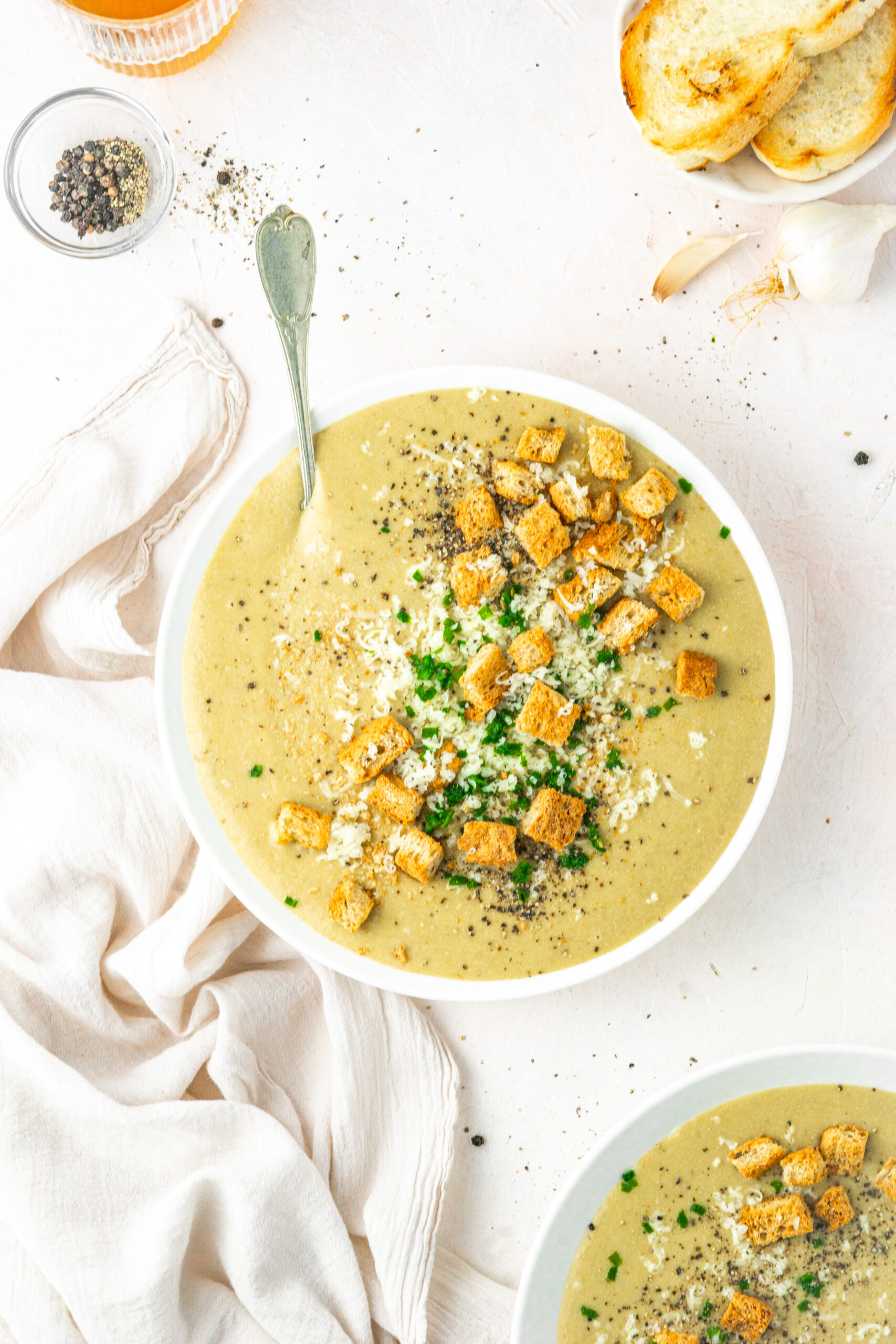 30 clove garlic soup served in a white bowl top down view