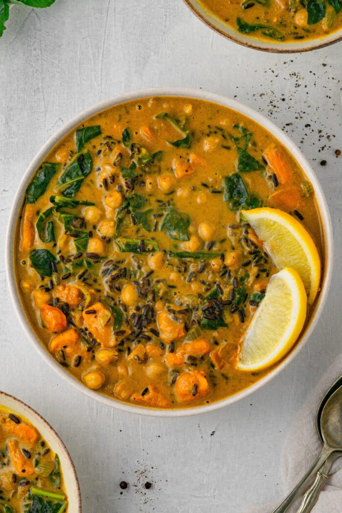 vegan creamy wild rice soup in a white bowk top down close up