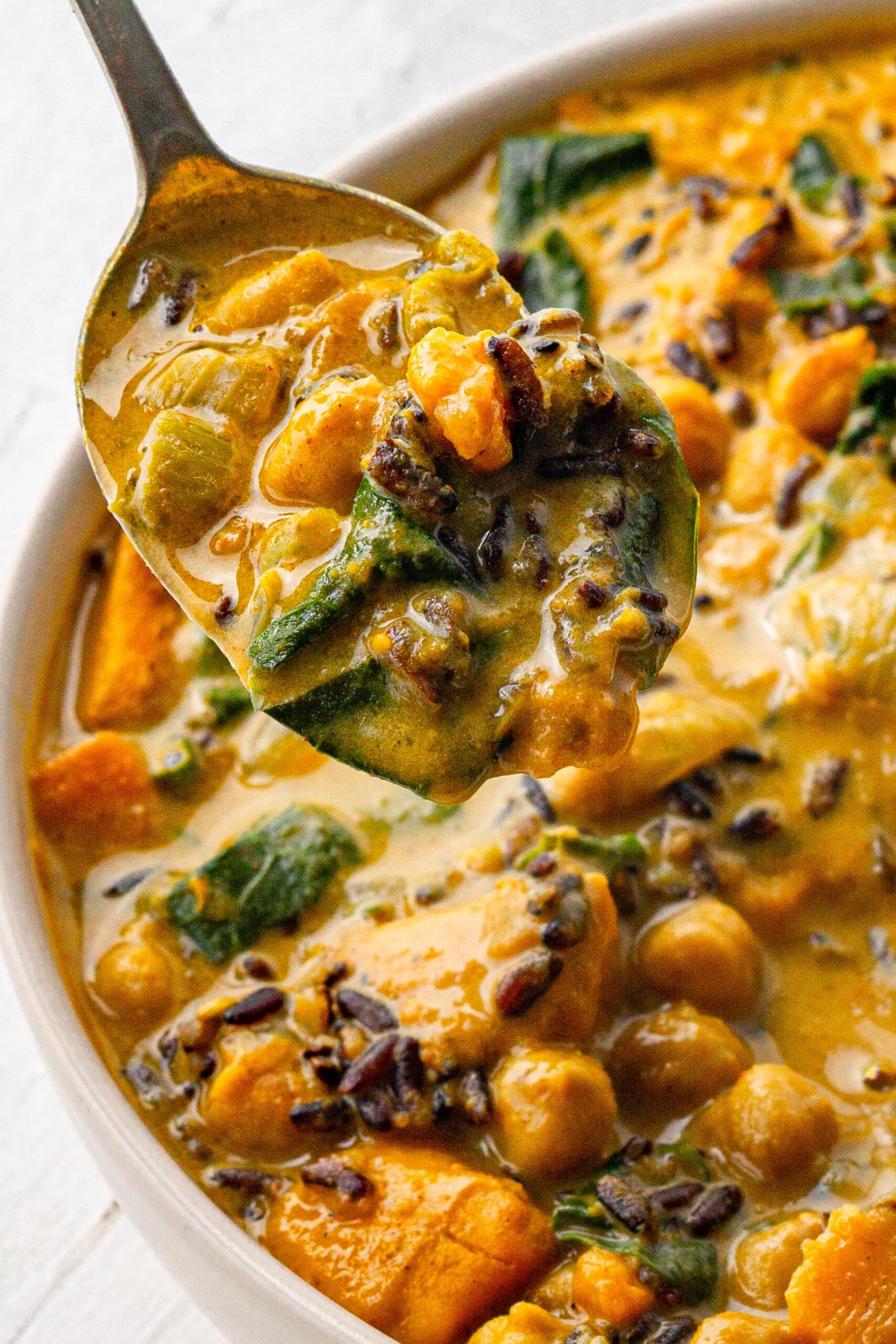a spoonful of vegan creamy wild rice soup close up