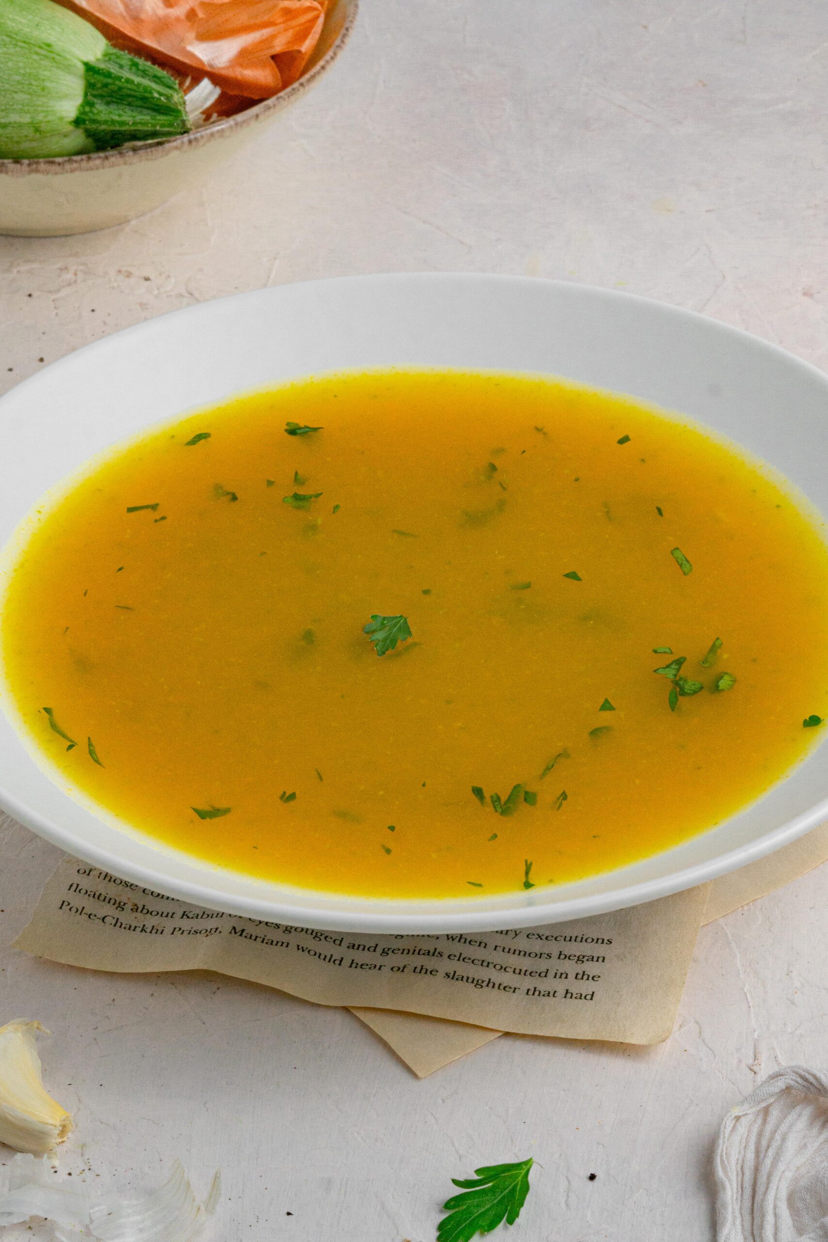 hidden veggie broth served in a white bowl with fresh parsley