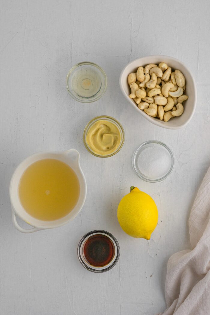 ingredients for healthy vegan mayonnaise laid out on a light background