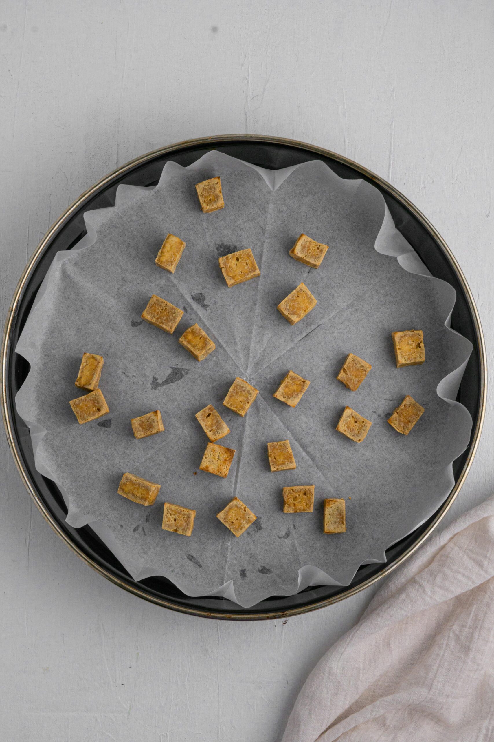 cubed tofu baked until cripy in a lined baking pan