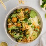 top view a bowl with sheet pan tofu and broccoli seved with rice and green goddess sauce