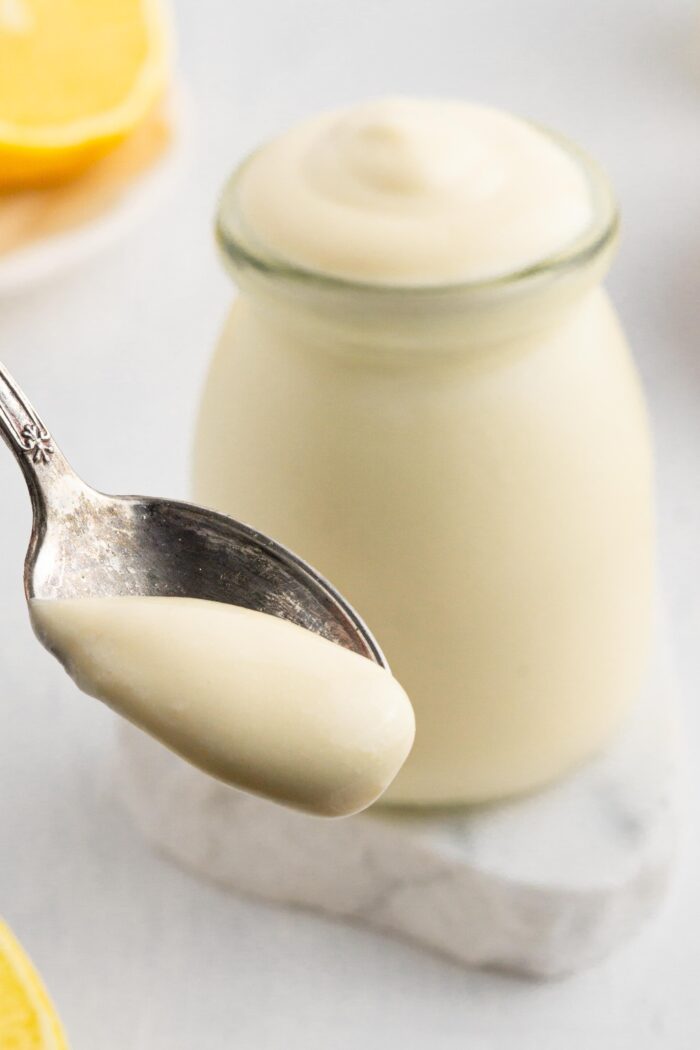 spoonful of vegan mayo with the jar in the background