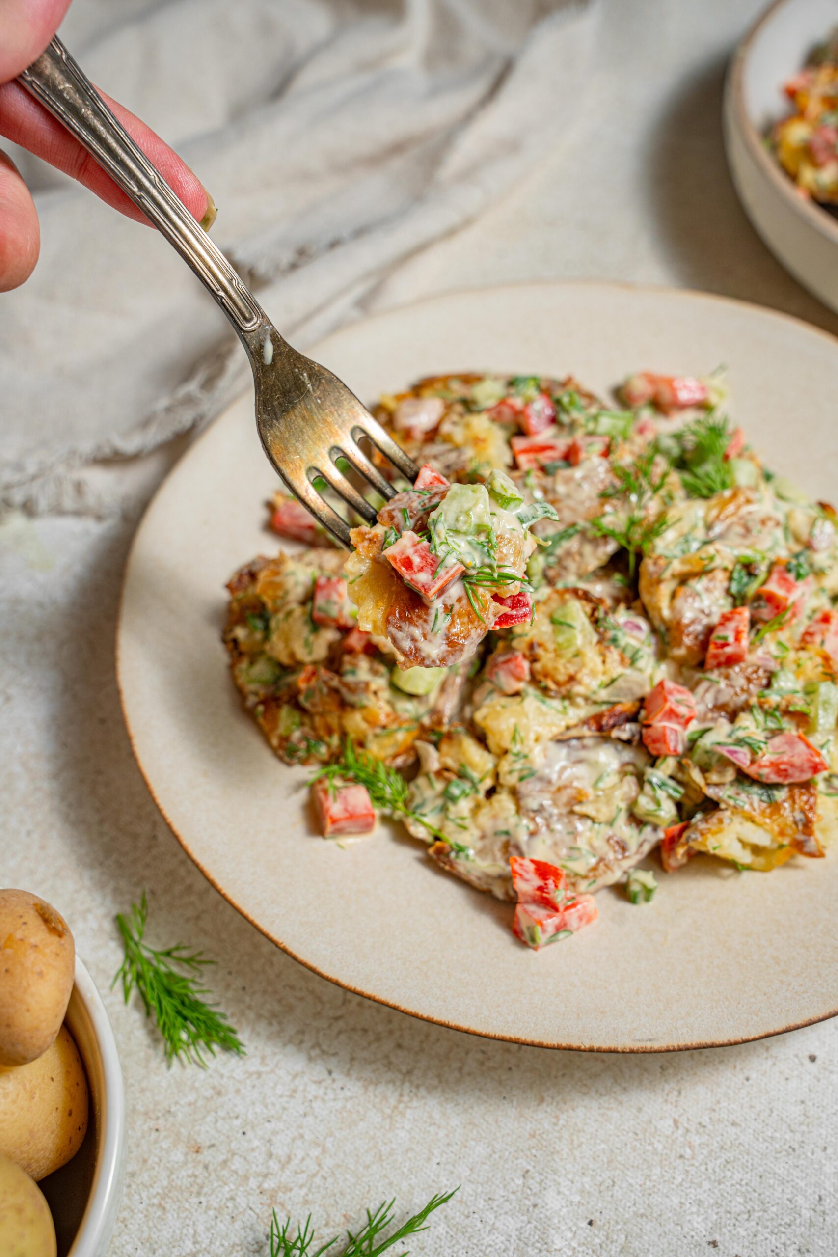 smashed potato salad picked up by a fork