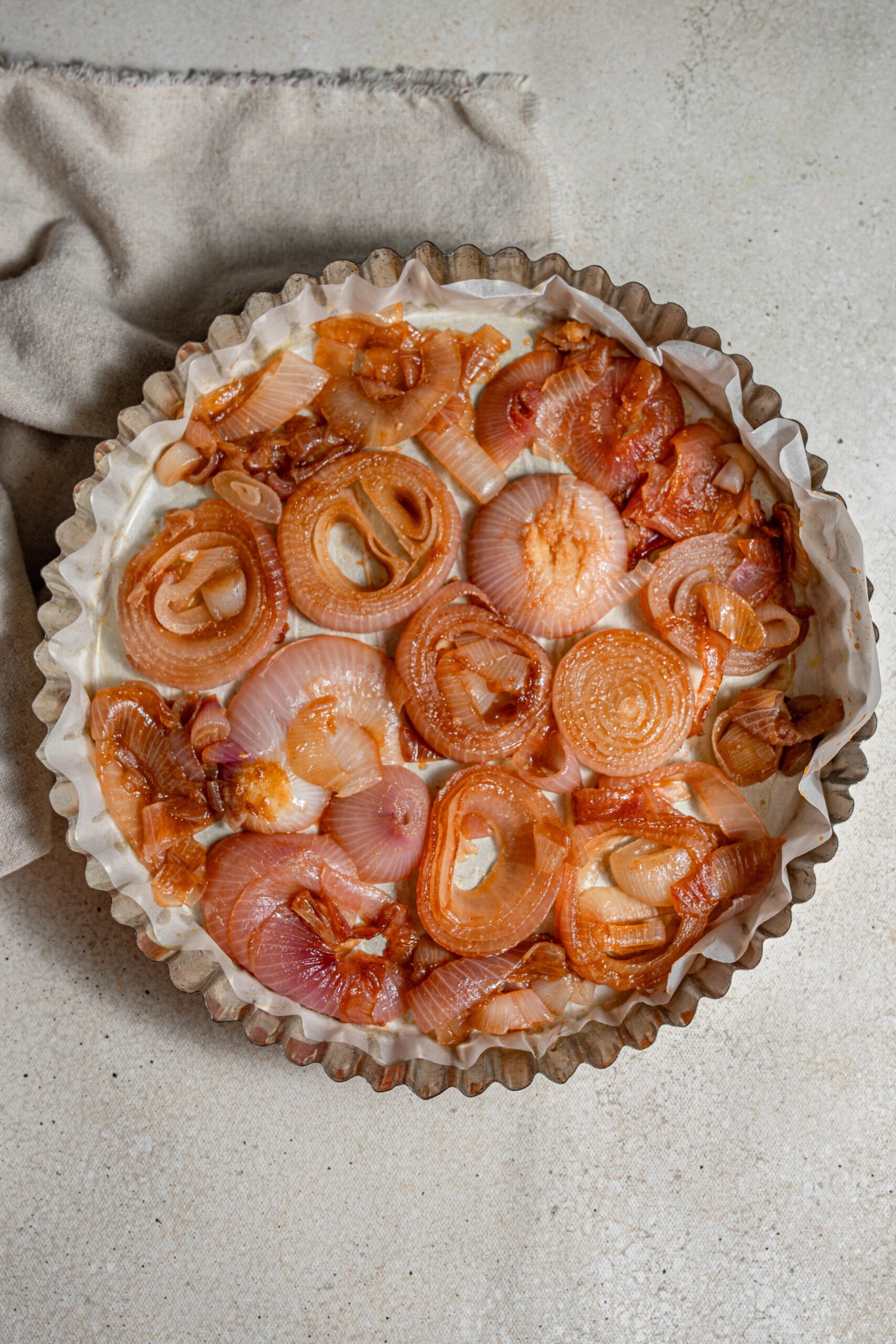 caramelized red onions in a pie tin spread out
