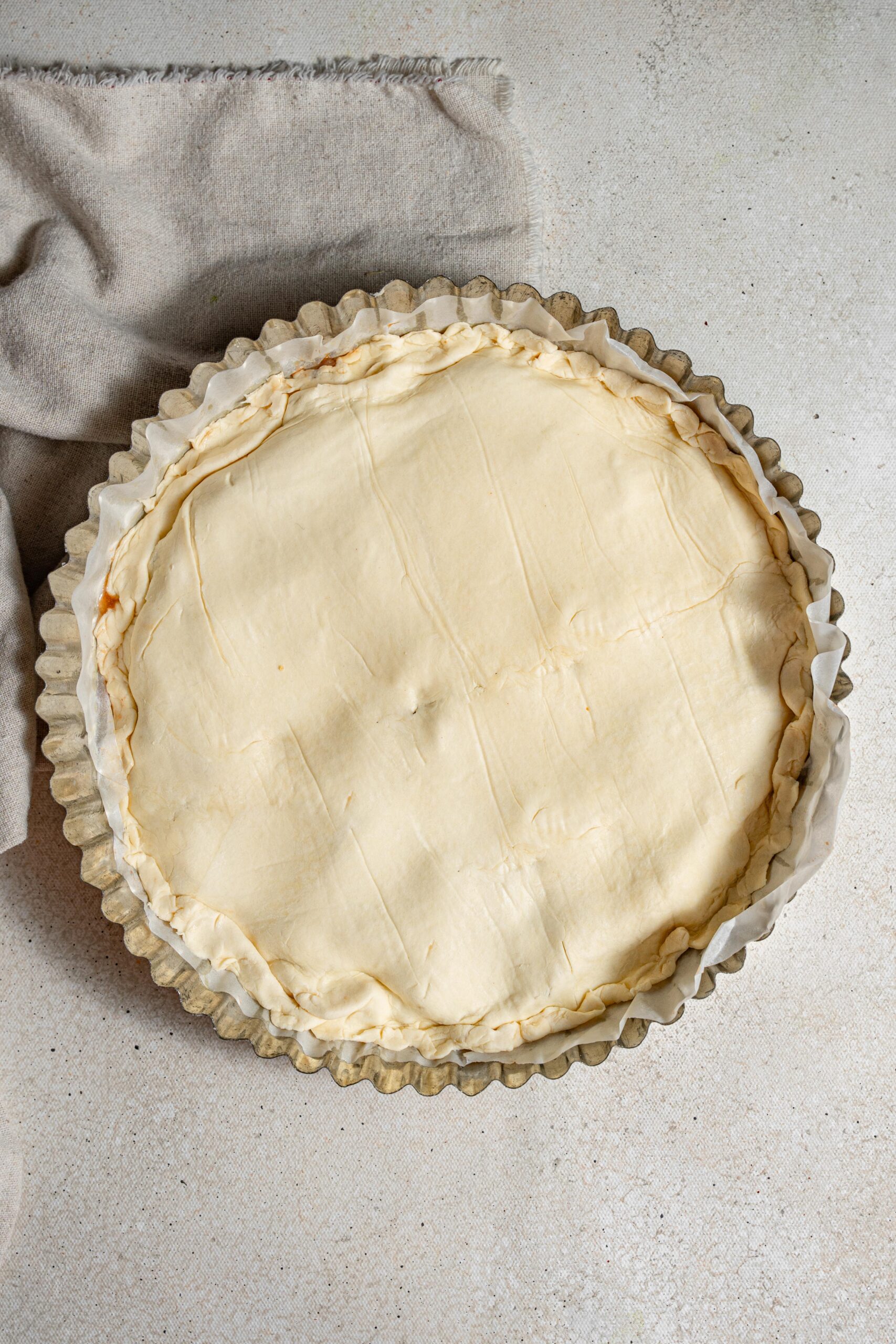 onions covered with puff pastry in a pie tin