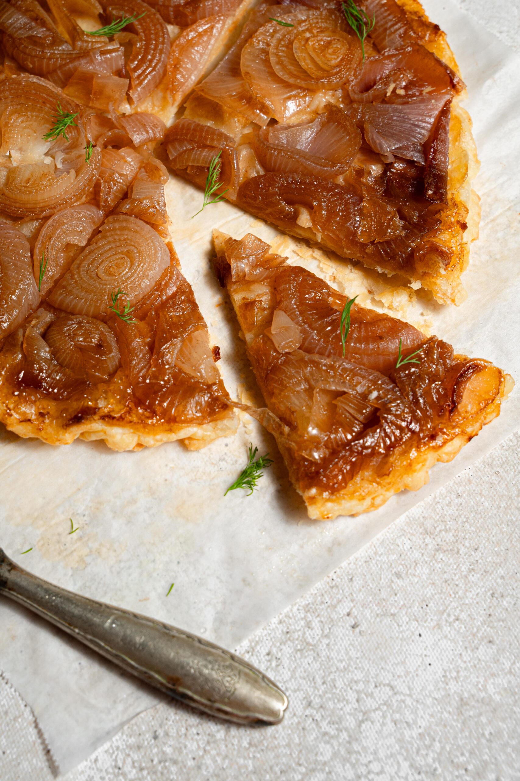 close up of a caramelized onion tart slice