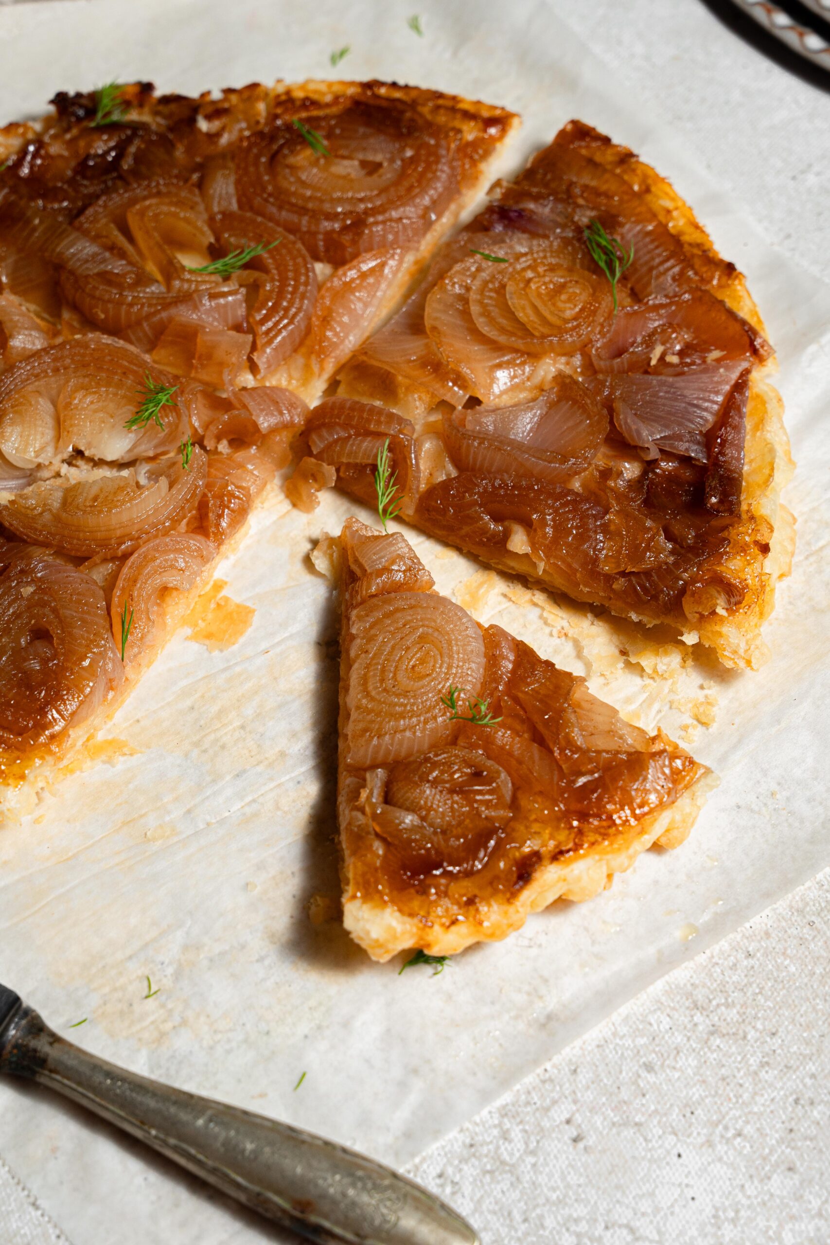 close up slice of caramelized onion tart