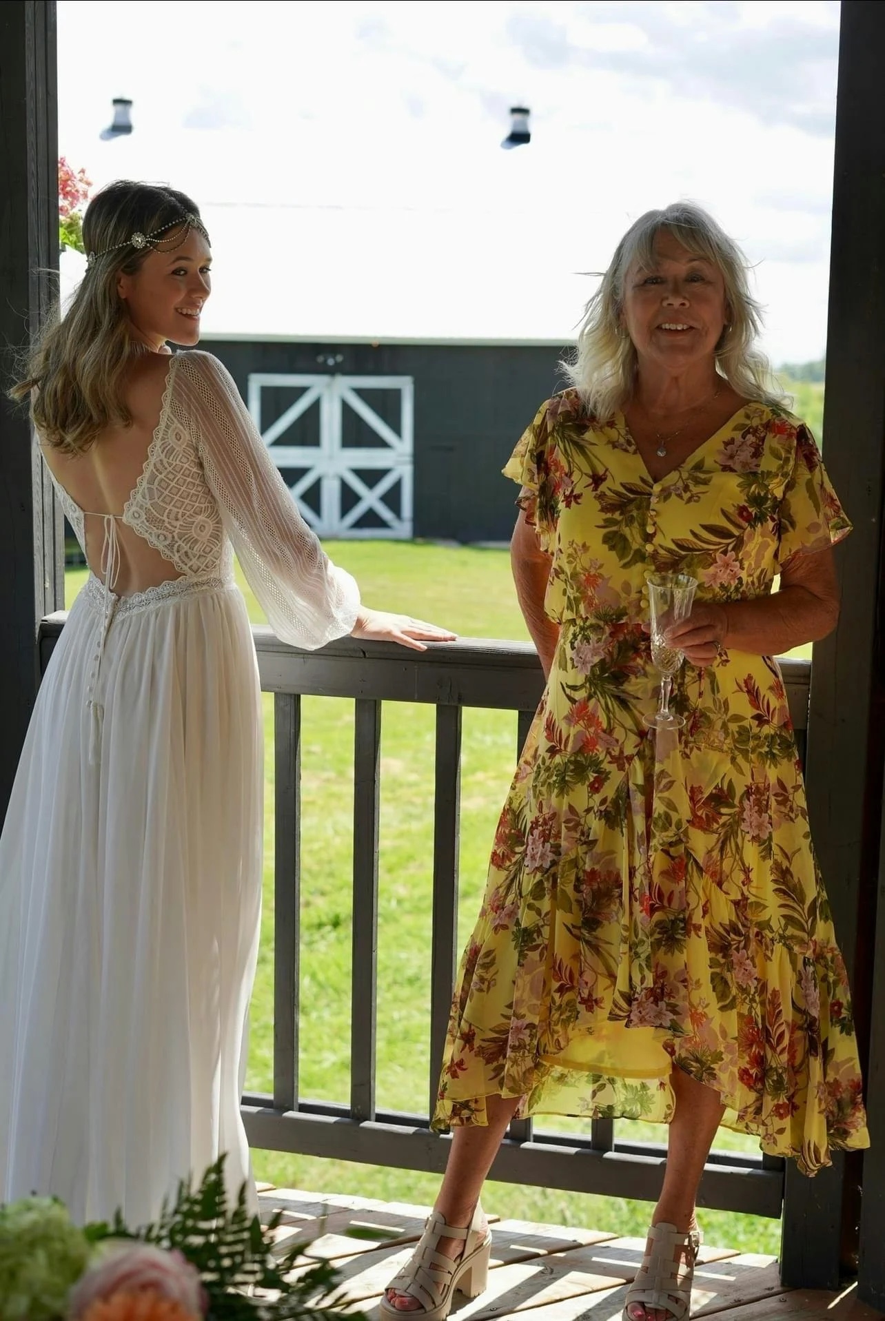 Carleigh in her wedding dress and her mom Debbie on a terrace for a pre-wedding photo shoot