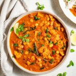 a bowl of peanut stew with sweet potato cauliflower and chickpeas top down view