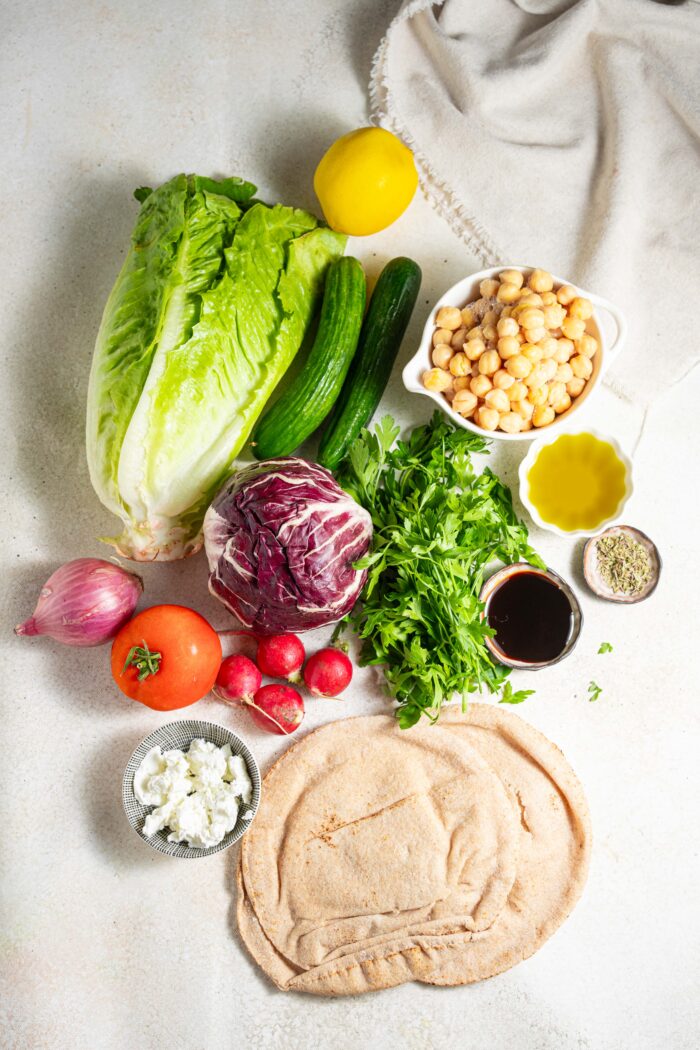 fattoush salad ingredients arranged on a light background