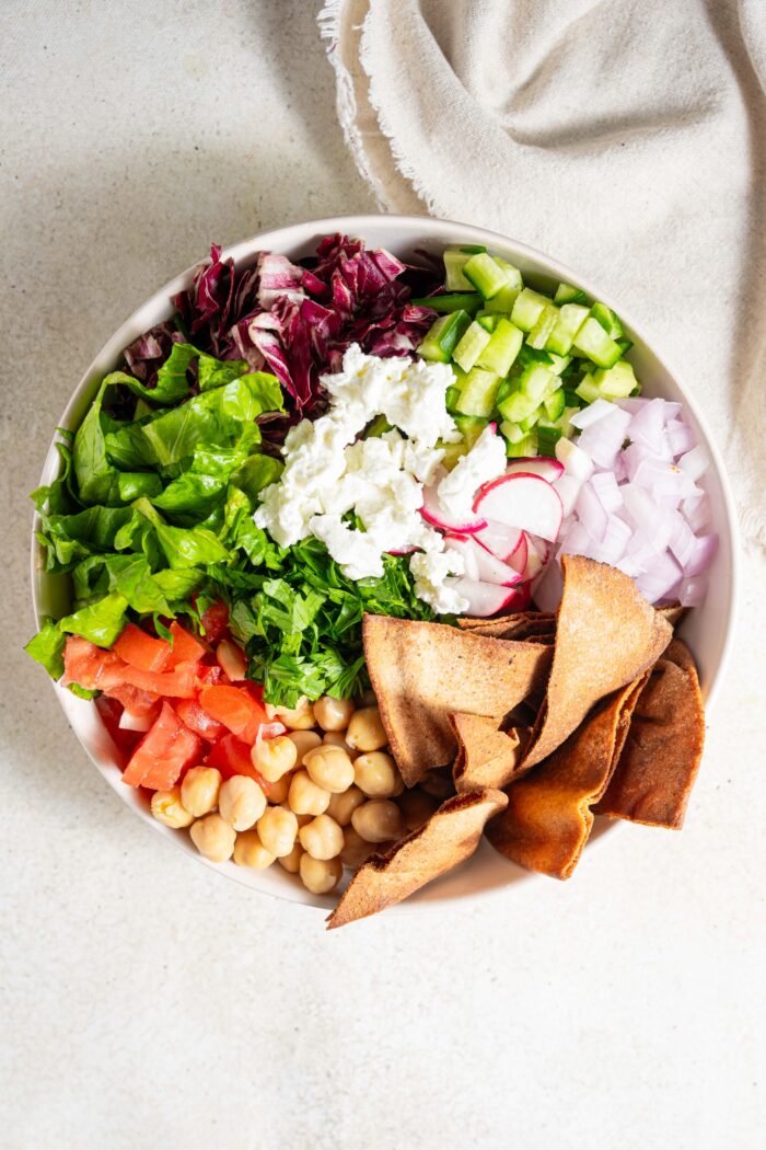 fattoush salad with chickpeas served in a large white bowl
