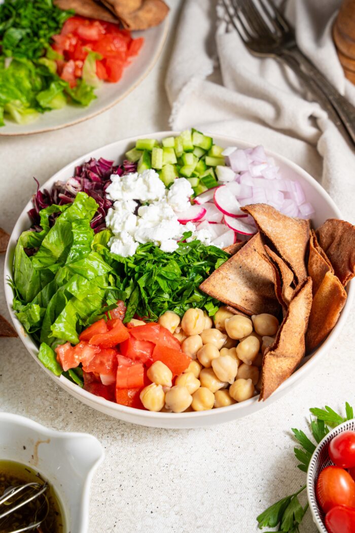 fattoush salad with chickpeas with some of the ingredients visible in the shot