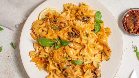 title image of one pan caramelized onion pasta on a light background