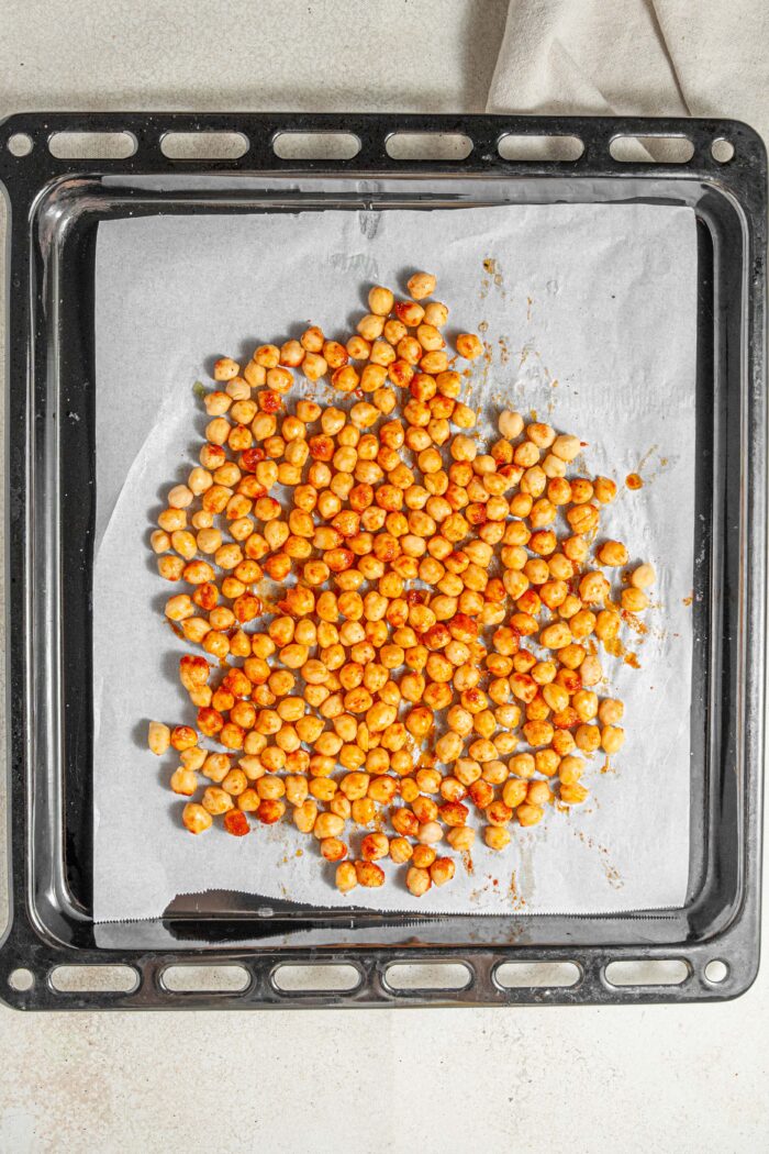chickpeas on a sheet pan mixed with spices and oil