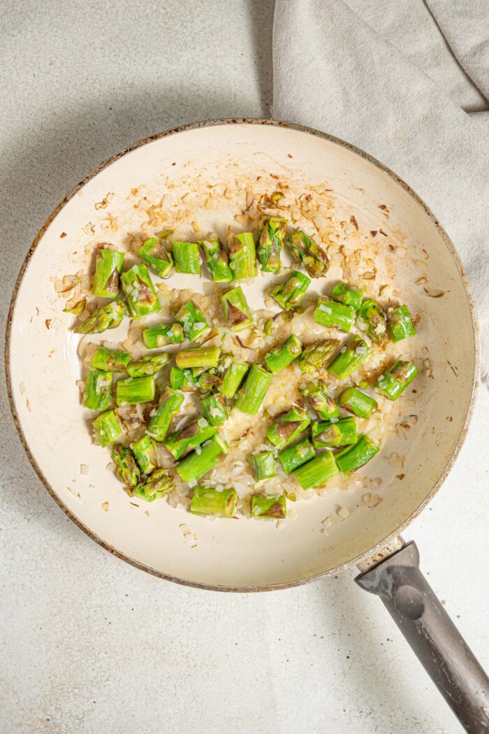 asparagus and onion on a frying pan