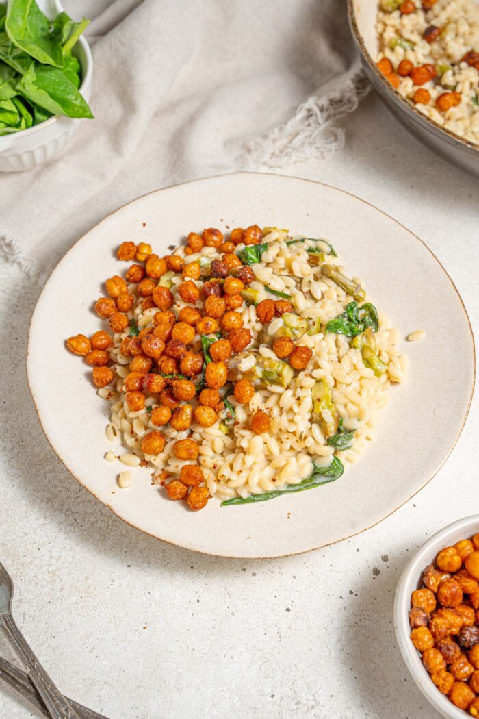 creamy lemon orzo served on a white plate with spiced roasted chickpeas
