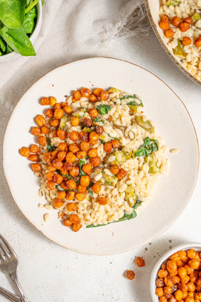 creamy lemon orzo served on a white plate with spiced roasted chickpeas