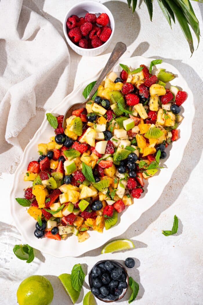 fresh fruit salad recipe with mint and lime served iin a large oblong dish