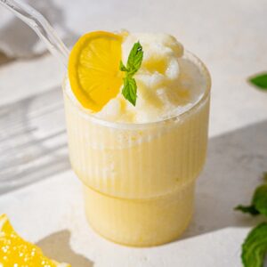 creamy iced lemonade in a glass against a light background