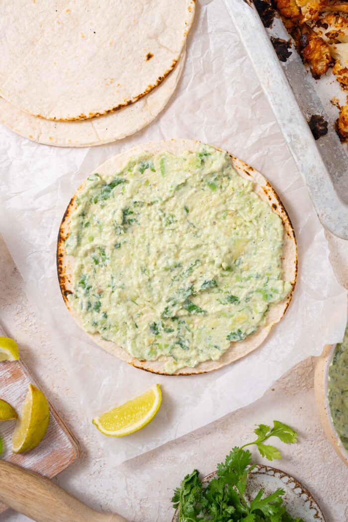 tortilla with some avocado crema spread on it