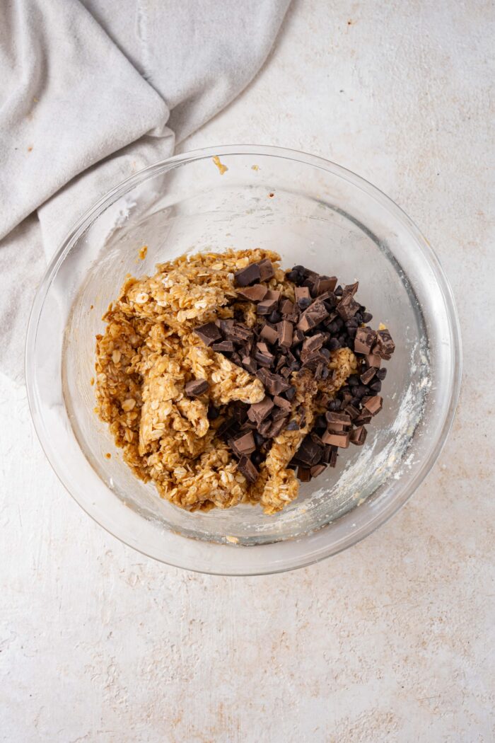 chocolate chunks being folded into the tahini cookie dough