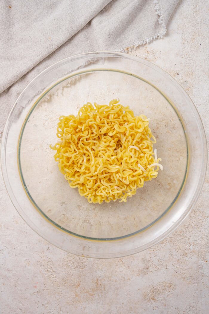 Cooked ramen noodles in a glass bowl.