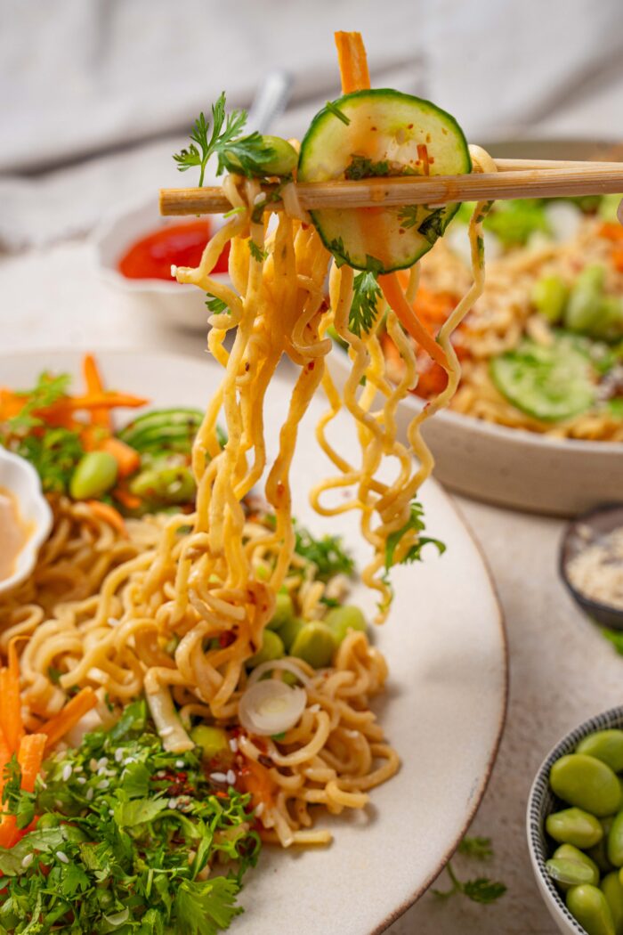 cold sesame noodles being pulled up from the plate with chopsticks