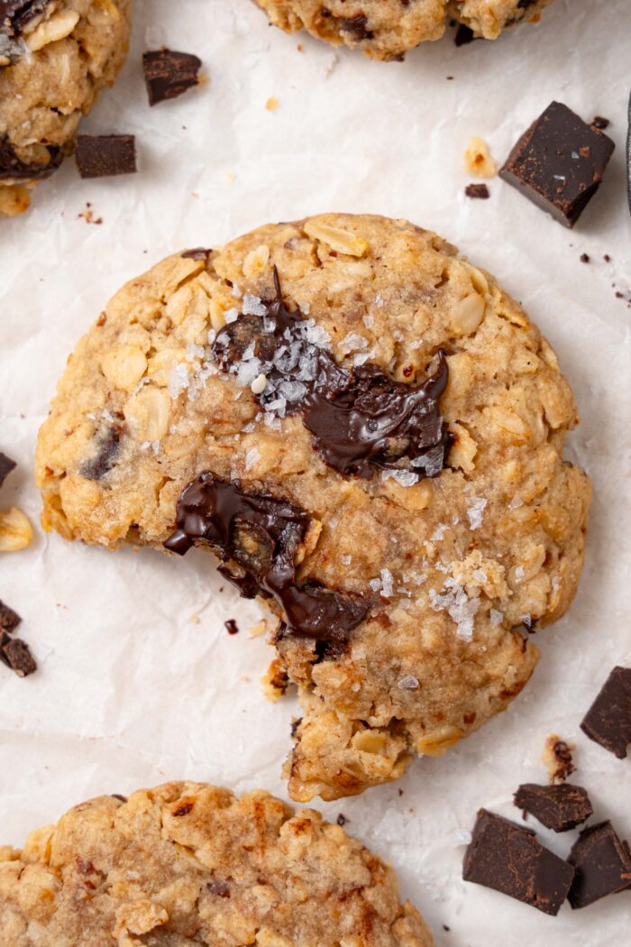a vegan tahini chocolate cookie with a bite taken out of it