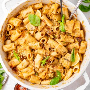 Creamy vegan zucchini lemon pasta in a white casserole dish.