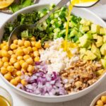 Lemon vinaigrette drizzled over the cucumber chickpea salad ingredients.