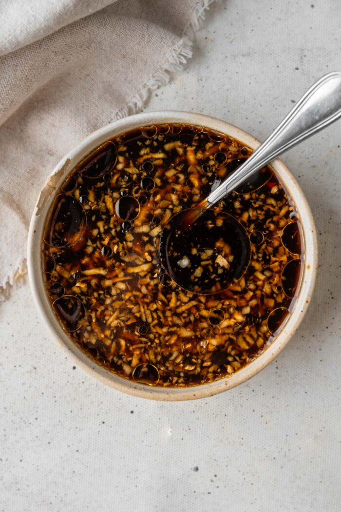 Soy, chili, and sesame dressing mixed together in a bowl.