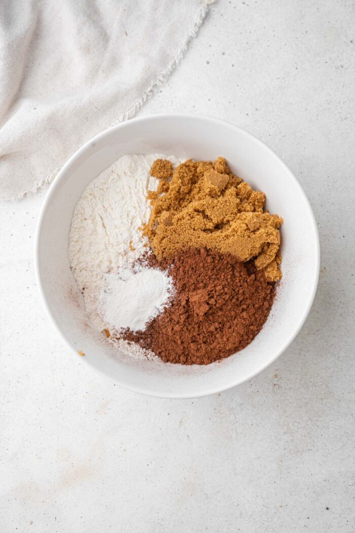 Dry ingredients (including cocoa, flour, brown sugar, and baking powder) in a mixing bowl.