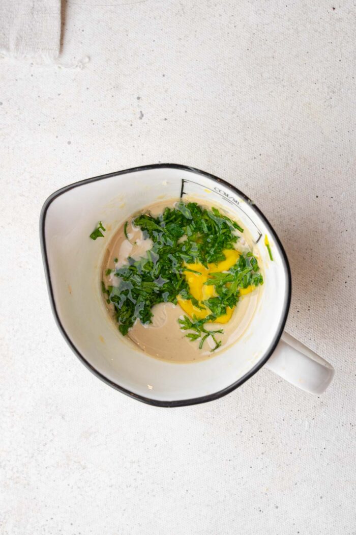Dressing ingredients in a ceramic jug.