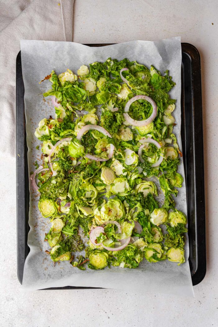 Roasted kale and Brussels sprouts, still in the lined sheet pan.