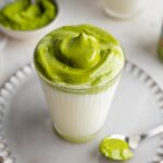 Beautifully presented dalgona matcha in a glass.